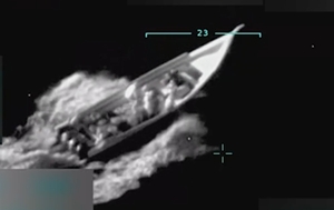 Infrared surveillance image of a high-speed boat in international waters, showing multiple individuals aboard and military-style targeting overlays.